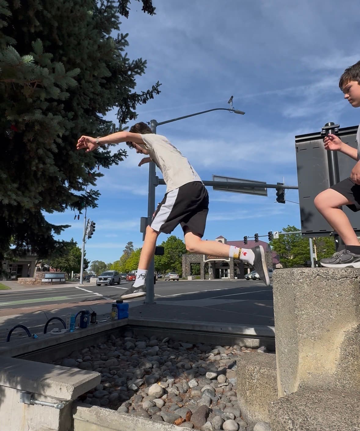 Kids doing parkour on concrete obstacles in downtown Bend