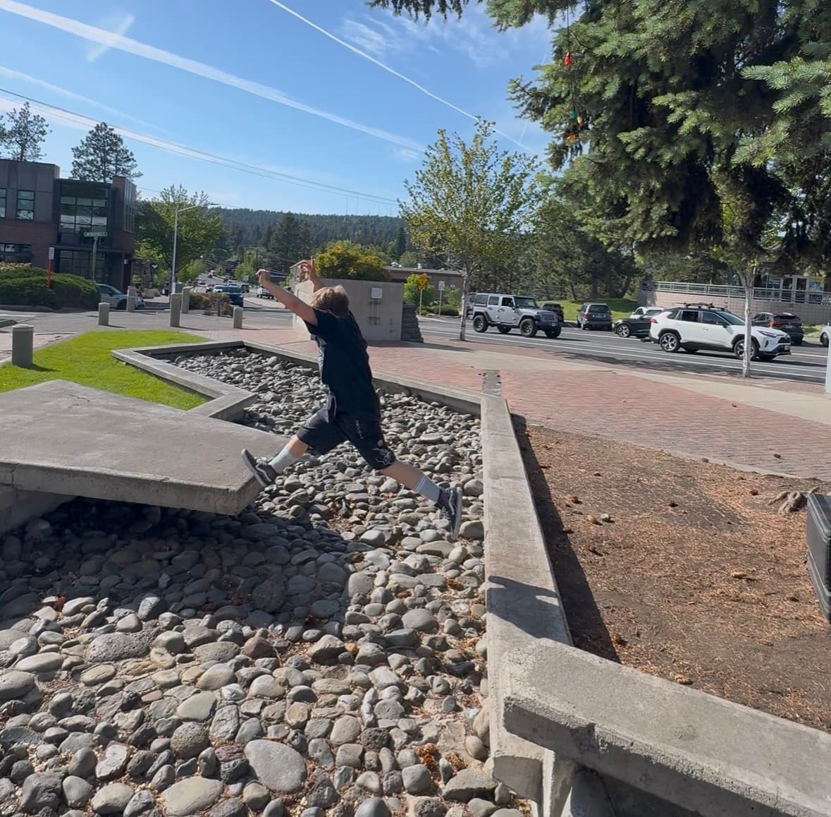Student jumping across concrete obstacles outdoors in Bend, Oregon